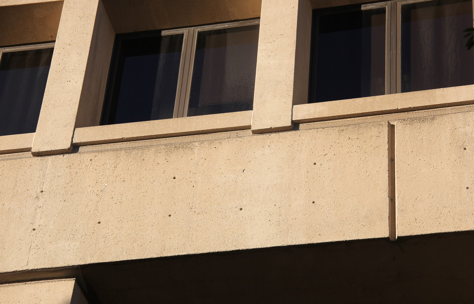 Close-up of a building facade showing layered cladding panels